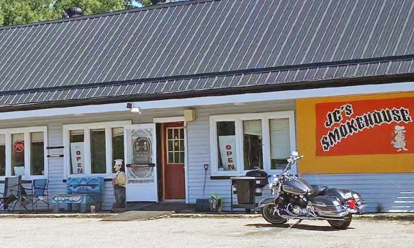  motorcycle parked in front of restaurant