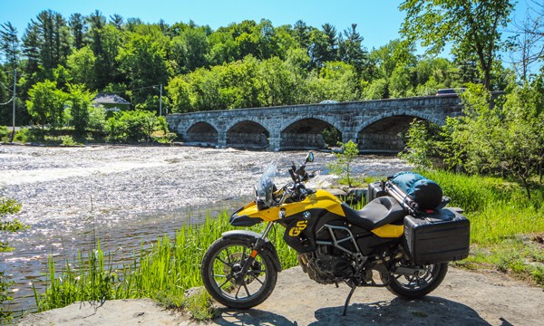  Motorcycle in front of a stone bridge