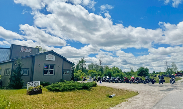 Distillery exterior with motorcycles parked outside